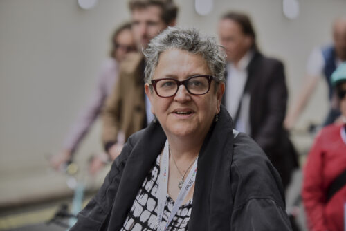 A smiling woman with glasses among riders at the 2019 Parliamentary Bike Ride
