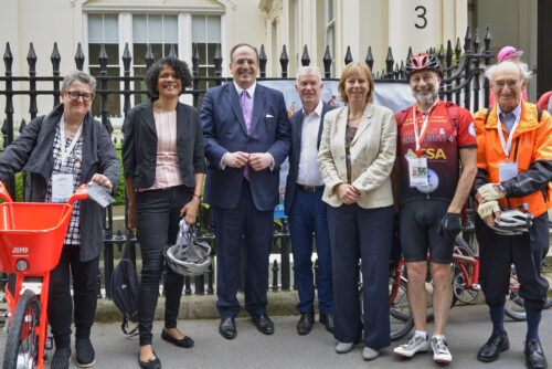 MPs, peers and campaigners lined up with their bikes in front of railings on the 2019 Parliamentary Bike Ride