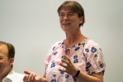 A smiling woman in a floral top speaking at the 2023 Parliamentary Bike Ride event