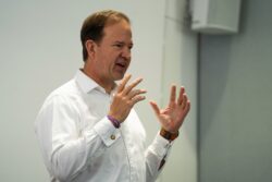 A man in a white shirt gesturing as he speaks at the 2023 Parliamentary Bike Ride event