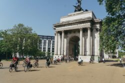 Riders cycling past the Wellington Arch at Hyde Park Corner on the 2023 Parliamentary Bike Ride